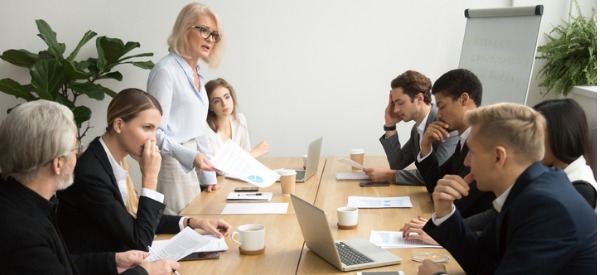 senior-woman-boss-scolding-employees-for-bad-work-at-meeting-picture-id924520268